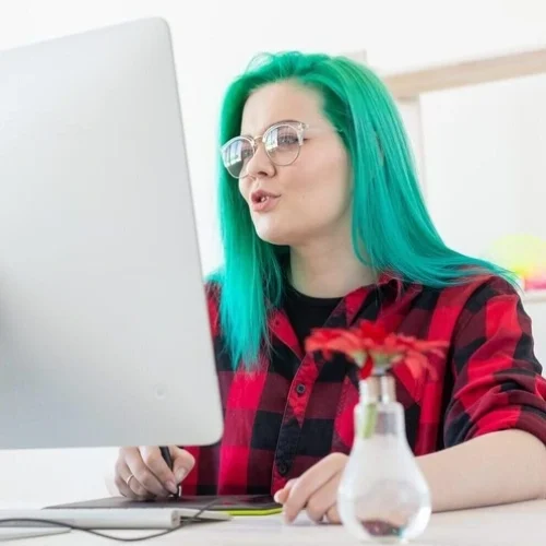 illustrator-creative-web-design-concept-female-graphic-designer-with-green-hair-at-work-e1734947173867